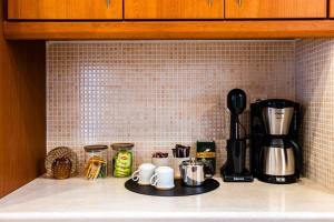Coffee and tea making facilities at Filiatra Downtown Cozy Retreat - Homely Vibes