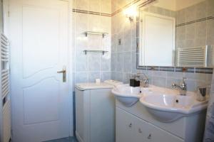 a white bathroom with two sinks and a mirror at Schinias Bright Spacious Maisonette-Panoramic View in Marathon