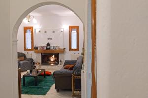 a living room with a couch and a fireplace at Forest Cosy House - Lagkadia Amazing View in Lagadia