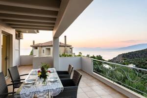 a patio with a table and chairs on a balcony at Kitries Summer Getaway - Eden Comfy Suite in Kitriaí