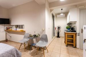 a room with a bed and a table and chairs at Kitries Summer Getaway - Eden Sandy Suite in Kitriaí