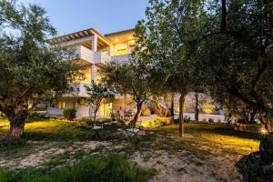 a house with a garden in front of it at Kitries Summer Getaway - Eden Sandy Suite in Kitriaí +10 photos