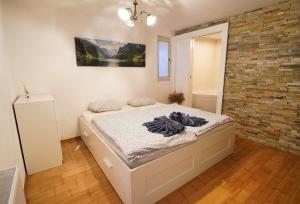 a bedroom with a bed and a brick wall at Apartment Mojstrovka with Sauna and free parking on site in city center in Kranjska Gora