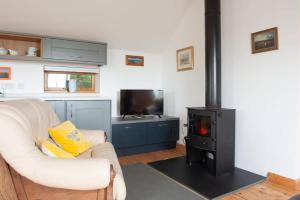 sala de estar con sofá blanco y fogones en Dartmoor Barn on North Hessary Tor, en Yelverton