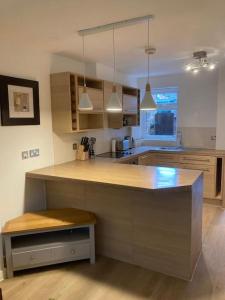 a kitchen with a large island in the middle at Park Cottage - Cosy 1 bedroom in Spinney Hill