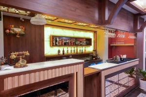 a kitchen with a bar with a lot of alcohol at Hotel Pragati in Pune