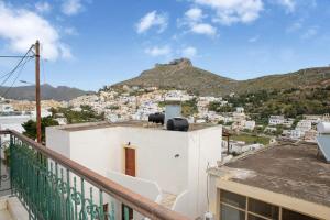 a view of a city from the balcony of a building at Neoclassical Splendor Unique Experience in Leros in Panteli