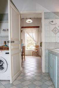 a laundry room with a washer and dryer at Neoclassical Splendor Unique Experience in Leros in Panteli