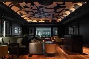 a living room with a coffered ceiling and tables and chairs at Hotel Casa Lucia in Buenos Aires