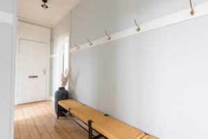 a hallway with a bench in a room at Perfect Holiday Homes Near Amager Beach in Copenhagen