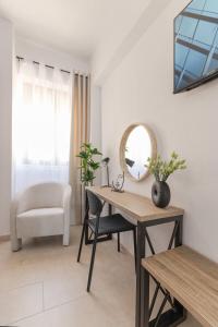 a room with a desk and a mirror and a chair at Knights Golden Loch - Rhodes Unique Getaway in Rhodes Town