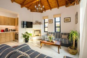 a living room with a couch and a table at Mani Stone Built Home A breath Away to the Sea in Stoupa +45 photos