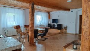 a living room with a table and chairs and a kitchen at STANICA in Nowy Gierałtów