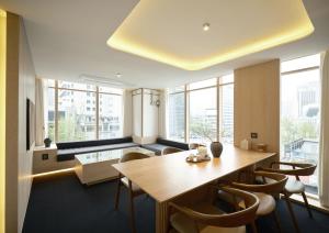 a dining room with a table and chairs at UH Suite Seoul Deoksugung in Seoul
