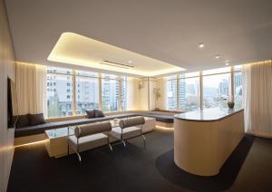 a living room with a couch and chairs in a building at UH Suite Seoul Deoksugung in Seoul