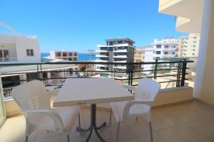 a table and chairs on a balcony with a view at Afrimi Relax Apartments in Sarandë