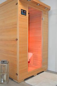 a sauna with a wooden door in a room at Chalet Auszeit in Olsberg