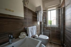 a bathroom with a toilet and a sink and a tub at Hotel Maarea in Milano Marittima