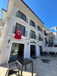 a building with a flag on the front of it at Cennet Life Otel in Fethiye