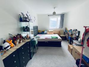 - une chambre avec un lit et un bureau avec des boîtes dans l'établissement Your ideal ExCel London- O2 Arena - LCY Airport homestay, à Barking