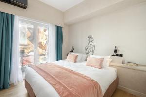 a bedroom with a large bed and a window at COLORS Hotel Athens in Athens