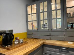 a kitchen with a counter with a coffee maker on a wooden counter top at Charming 2-Bed House in Llansteffan in Llanstephan