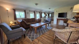 a living room with a couch and a table at Wijndomein Erve Wisselink in Eibergen