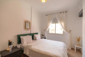 マラケシュにあるBrand new cool vibe Appartement in the heart of Marrakesh Kids Friendlyのベッドルーム(白いベッド1台、窓付)