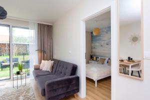 a living room with a couch and a bedroom at Golden Sand - Baltic Line in Gdańsk