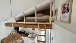 una camera da letto con un letto a castello in una stanza di Logement Cosy plein centre village avec mezzanines a Venerque
