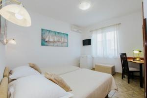 Postel nebo postele na pokoji v ubytování Hotel Vila Tina