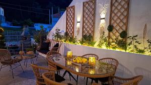 a table and chairs on a patio at night at Vithos in Agnontas