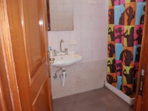 a bathroom with a sink and a mirror at Vazakas Rooms in Mytilene +56 photos