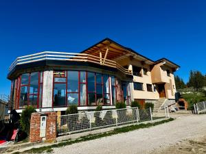a house with a lot of windows on top of it at Vlasic Odmor - Villa Wellnes & spa in Vlasic