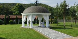 a gazebo in the middle of a park at Hotel ELYSIUM in Irshava +52 photos