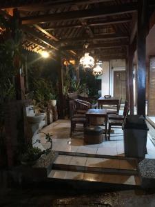 a patio with chairs and a table on a patio at Mbah Oden Homestay Borobudur in Mendut