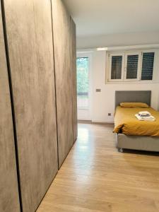 a bedroom with a bed and a wooden floor at Regina design apartment Lugano in Lugano