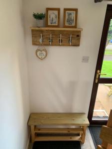 a wooden bench sitting in the corner of a room at Cosy cottage between Penzance and St Ives in Gulval