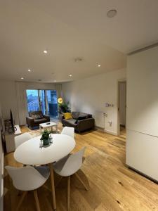 a living room with a white table and chairs at Lovely 1-Bed Apartment in London in London
