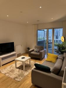 a living room with a couch and a tv at Lovely 1-Bed Apartment in London in London