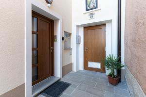 a door of a building with a plant next to it at Apartmaji Ema in Koper