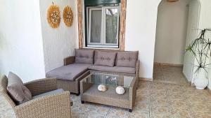 a living room with a couch and a table at Vithos in Agnontas