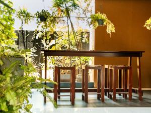 a wooden table with two chairs and a table at The Panorama Negombo in Negombo