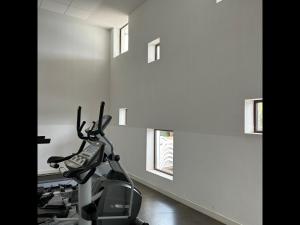 a scooter parked in a room with windows at Cosy plage - Appt climatisé avec piscine partagée in Sète