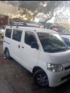 a white van parked in a parking lot at Subira Guest House and Restaurant in Lamu