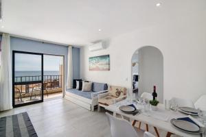 a living room with a table and chairs and a couch at Luxury Beach View - Praia da Rocha in Portimão