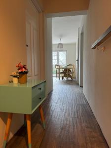 a hallway with a green dresser and a dining room at Villa Marbela in Ustka