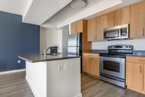 a kitchen with a stove and a microwave at East Cambridge 1br w gym wd near T stop BOS-958 in Boston