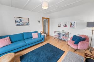 a living room with a blue couch and a table at Beautiful 1 bedroom apartment with free on street parking in Oban