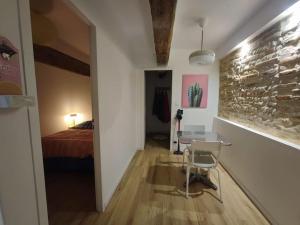 a room with a bed and a table and a chair at Appartement T2 - RDC in Seysses